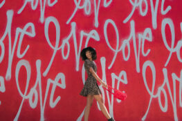 woman stands for a wall with love