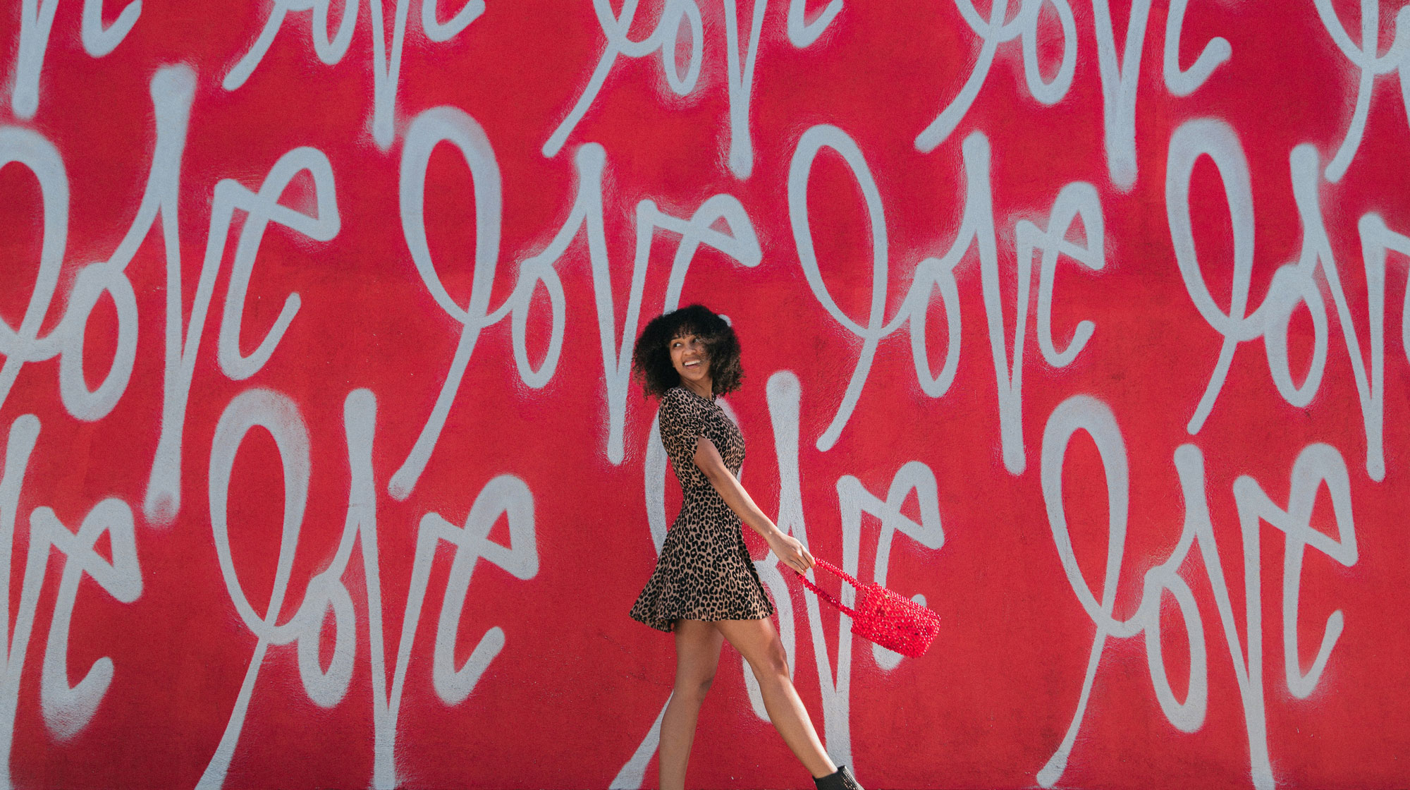 woman stands for a wall with love